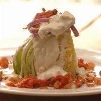 Blt Wedge Salad · Iceberg lettuce, smoked bacon, sundried tomatoes, grilled red onion, and crumbled bleu chees...