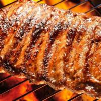 Grilled Baby Back Ribs · Marinated with a Portuguese style sauce.