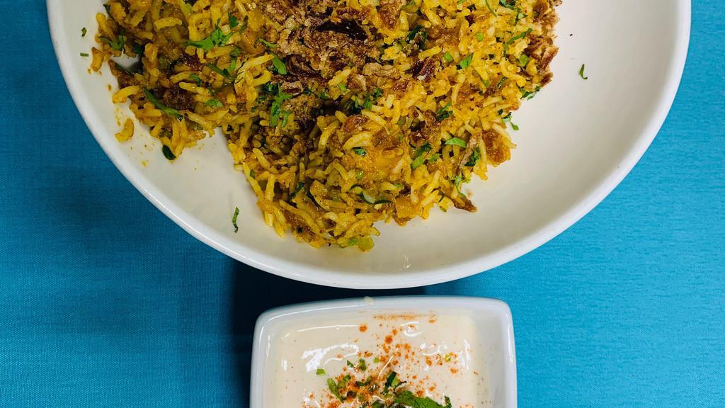 Chicken Biryani · Aromatic Basmati Rice cooked with spices and served with cucumber raita.