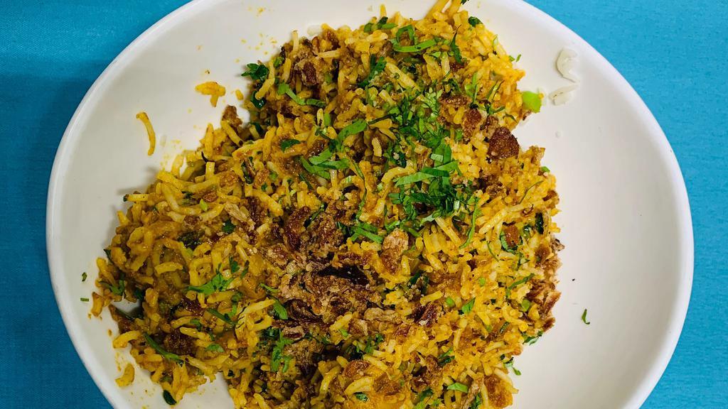 Lamb Biryani · Aromatic Basmati Rice cooked with spices and served with cucumber raita.