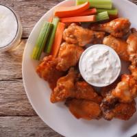 Spicy Buffalo Bone-In Chicken Wings · Fresh wings crisp to perfection tossed in tangy buffalo sauce.