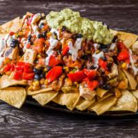 Build Your Nachos · Choice of protein and toppings over tortilla chips.