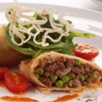Kheema Samosa · Spiced ground lamb stuffed in a Indian pastry.