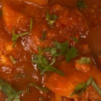 Chicken Vindaloo · Chicken in a hot and sour tangy tomato curry spicy sauce with potatoes.