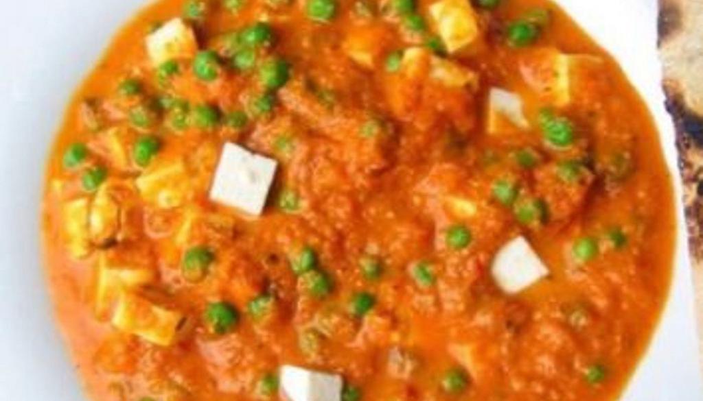 Matar Paneer · Green peas and paneer in a mildly spiced creamy tomato curry sauce.
