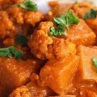 Alu Gobi · Potato and cauliflower cooked in a mild curry sauce.