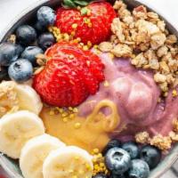 Almond Butter Coconut Bowl · Base: Blended with pure coconut, banana, coconut milk. Topped with granola, banana, strawber...