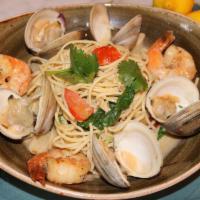 Amalfi Seafood Pasta · Sautéed shrimp and clams, tomato, roasted garlic, spinach, white wine lobster broth over lin...