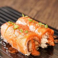 Fire Dragon Roll · Shrimp tempura, avocado topped with salmon Scallion, Sesame and special spicy sauce.
