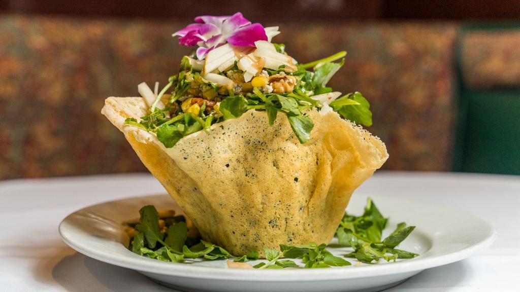 Insalata Di Cresione · Watercress with roasted walnut, corn, pears and gorgonzola cheese served in a parmesan cheese basket in a balsamic dressing.