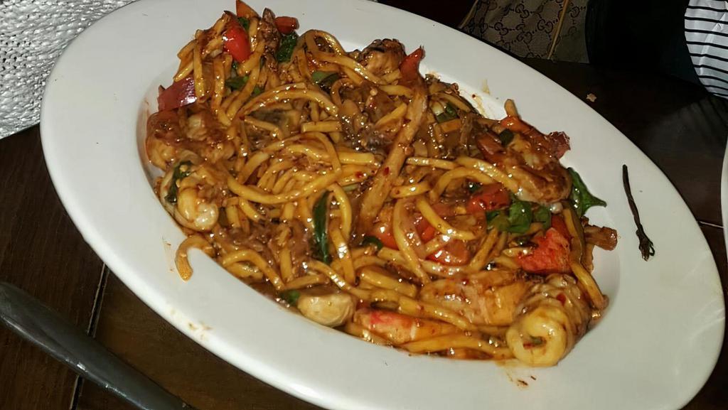Pad Kee Mao · Spicy. Stir-fried broad rice noodles with shrimp, chicken, basil leaves, onion, mushrooms, bell peppers in a hot and spicy chili sauce.