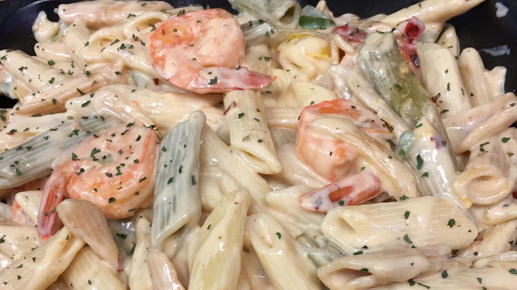 Shrimp Rasta Pasta · Caribbean style 10pc shrimp and pasta engulfed in a rich creamy spiced Alfredo sauce.