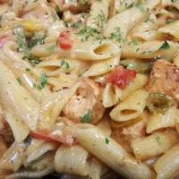 Salmon Rasta Pasta · Caribbean style filleted salmon and Pasta engulfed in a rich creamy spiced Alfredo sauce.