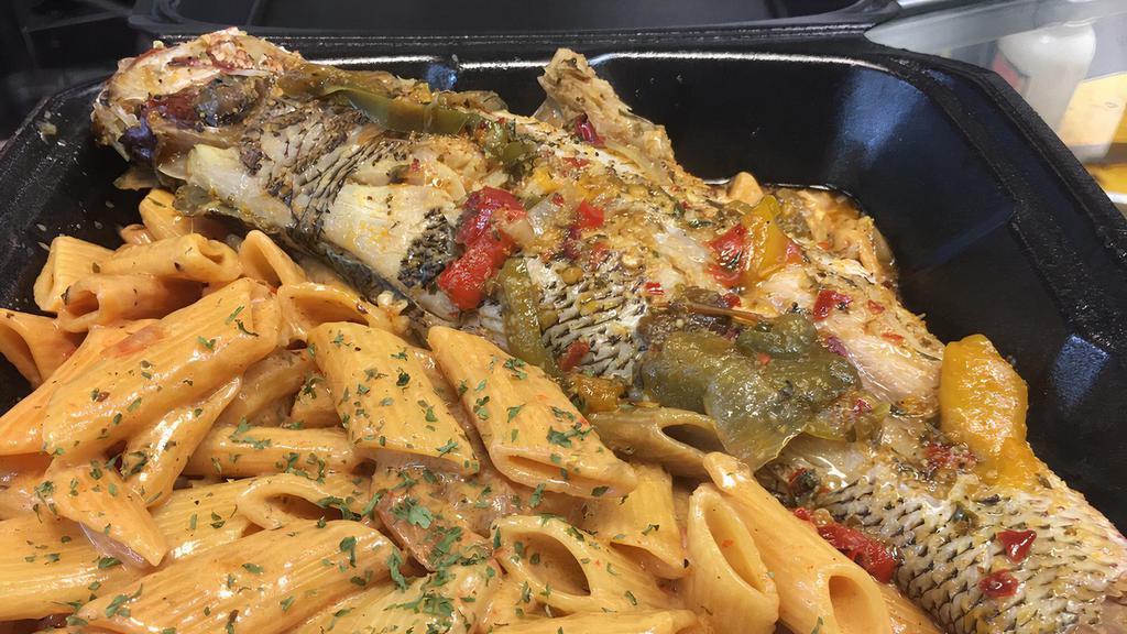 Snapper Rasta Pasta · Steamed Whole Snapper over our pasta engulfed in a rich creamy spiced Alfredo sauce.