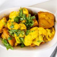 Aloo Gobi · Potatoes and cauliflower cooked in tomatoes, ginger, and spices.