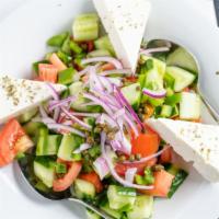 Horiatiki Salata · Tomatoes, cucumbers, red onions, peppers, capers and feta.