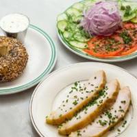 Sturgeon · Served with bagel, tomato, cucumber, onions, and capers.