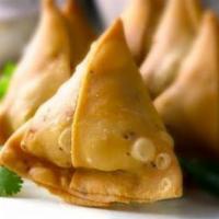 Samosa'S · Crispy triangular wheat dough pouches with a filling of potatoes, onion, peas, and spices.