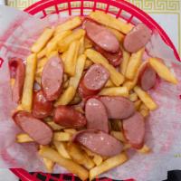 Salchipapa · Sliced hotdogs with french fries.
