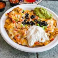 Macho Nachos · Melted cheese blend over nachos with pinto & black beans. Topped with scallions, black olive...