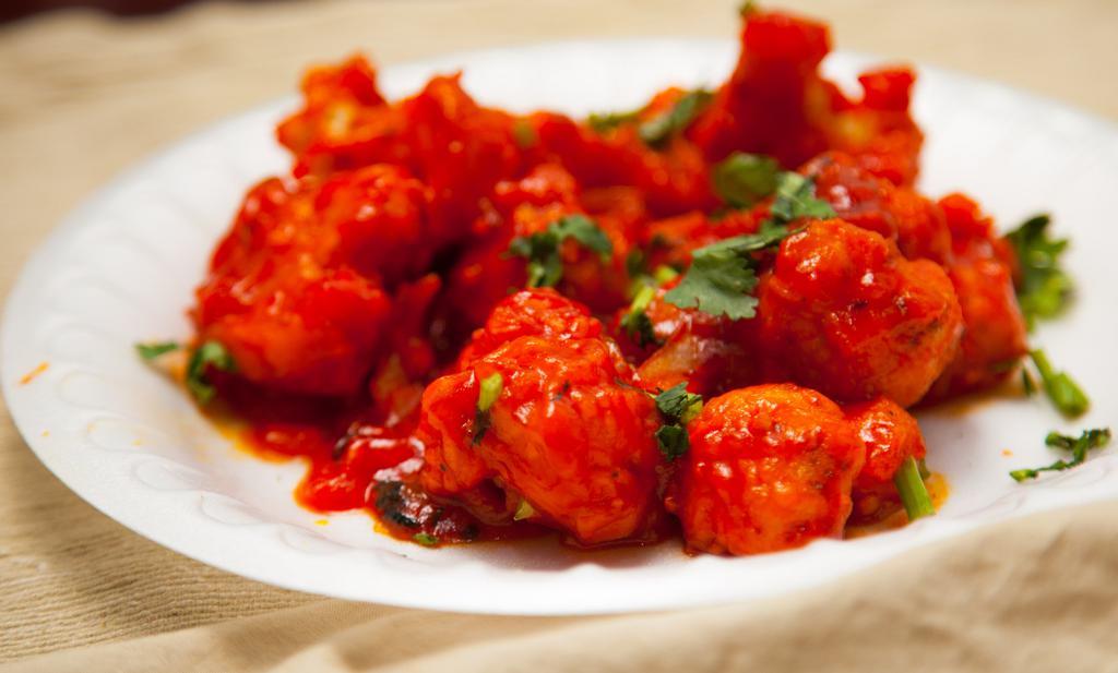 Lasooni Gobi (House Specialty) · Fresh cauliflower battered with garlic and mild spices.