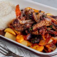 Lomo Saltado · Marinated beef steak stir fry with onions , tomato French fries , served with yellow rice or...
