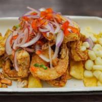 Jalea (Peruvian Fried Seafood) · Mix of seafood shrimp , calamari fish , yuca fríes and salsa criolla on top .