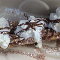 Churro · Jumbo churro rolled in sugar and cinnamon, topped with nutella and whipped cream.