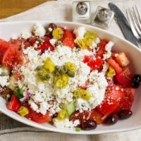 Horiatiki (Greek Salad) · A traditional Greek salad with lettuce, tomatoes, cucumbers, pepperoncinis, onions, capers, ...