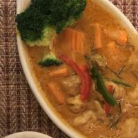 Panang Curry · Hot. Panang curry in thick coconut milk garnish with shredded kaffir lime leaves and thai ba...