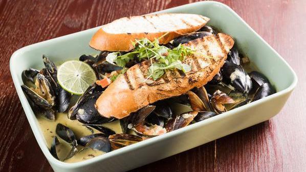 Mussels · garlic, bacon, cilantro, tomatoes, scallions and white wine huacatay sauce.