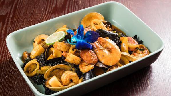 Black Paella · clams, mussels, shrimp, squid, chorizo, and saffron squid ink rice.
