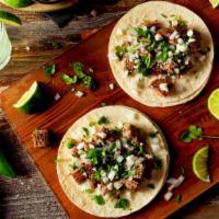Carne Asada (Steak) Tacos · Marinated steak, onions, cilantro, and avocado on a fresh made tortilla.