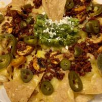 Chorizo Nachos · Chorizo with sautéed onion and peppers and topped with melted cheese loaded onto crispy tort...