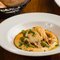 Hummus Mazze · Gluten-Free and Contains Sesame.  Topped with hot chickpea stew,  olive oil and  garnished w...