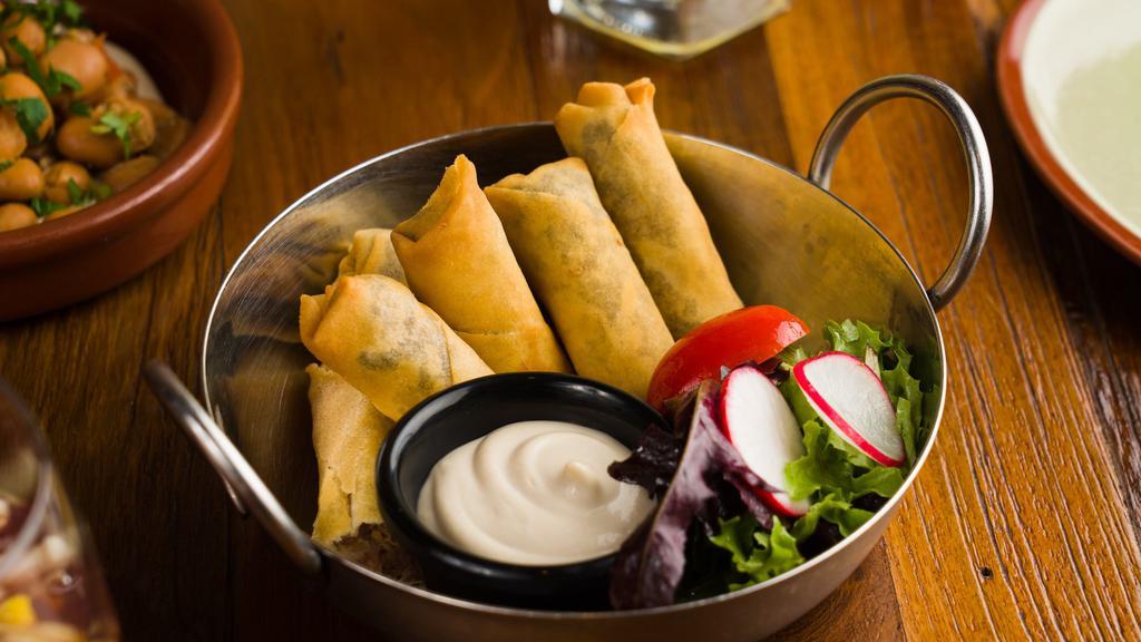 Moroccan Cigars · Contains Sesame.  Deep fried dough filled with vegan mince beef,  served with a side of tahini.