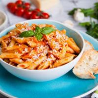 Penne Vodka · Mouthwatering pasta dish made with Penne pasta, vodka sauce, prosciutto, peas and mushrooms.