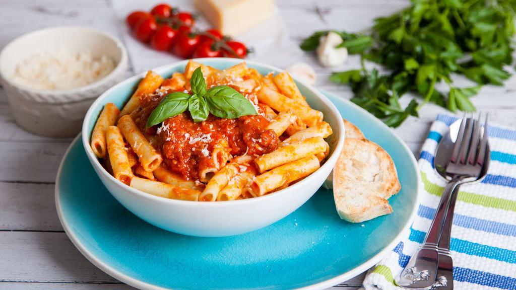 Rigatoni Bolognese · Mouthwatering pasta dish made with homemade bolognese sauce, rigatoni, fresh herbs, and a dollop of ricotta cheese.