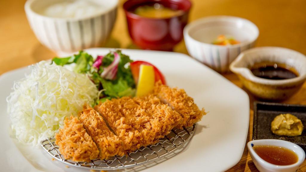 Tonkatsu · Breaded and deep fried silky pork loin cutlet served with original tonkatsu sauce. Served with white rice, miso soup (pork and vegetables), and homemade pickles.