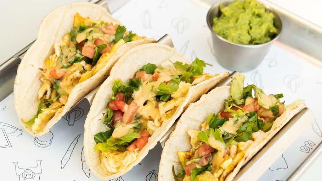 Breakfast Tacos · Three (gluten free) soft corn tortillas with scrambled eggs, house blend, ripe tomato, cilantro and fresh guacamole with chipotle sauce. Add toppings or cheese for an additional charge.