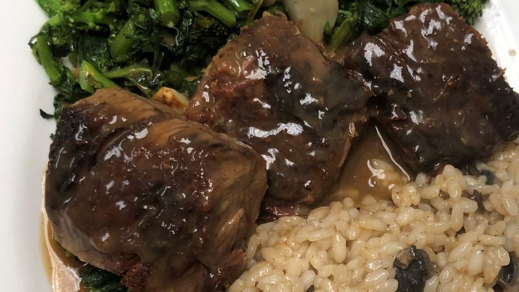 Braised Short Ribs · Short ribs slowly roasted with root vegetables served with mushroom risotto and sautéed broccoli rabe.