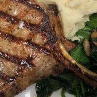Grilled Double Cut Pork Chop · Tender bone-in 14 oz. pork chop served with sautéed organic baby spinach and mashed potatoes.