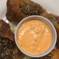 Philly Cheese Steak Egg Rolls · Chopped rib-eye steak, American cheese, sautéed chopped peppers and onions served with Russi...