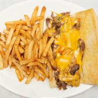 Philly Cheese Steak Sandwich · Thinly sliced rib eye, sautéed onions, mushrooms, bell peppers and American cheese on a long...