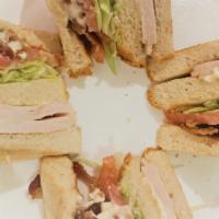 Traditional Turkey Club Sandwich · Baked turkey breast, applewood bacon, mayonnaise, lettuce and tomato on toast.
