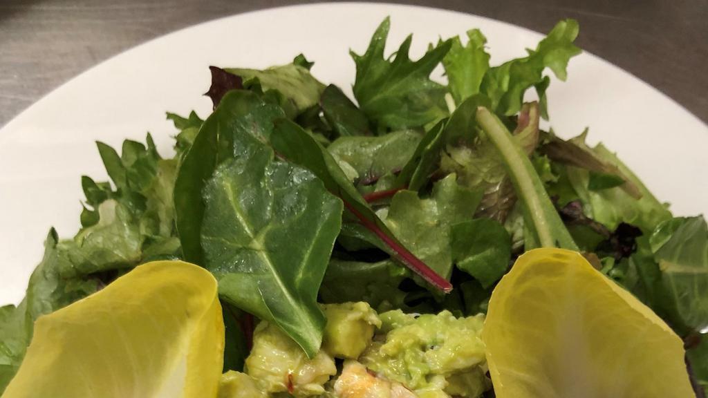 Crab And Avacado Salad · Made with fresh avocado, diced tomatoes and colossal blue point crab meat on a bed of organic baby greens tossed in a homemade lime vinaigrette.