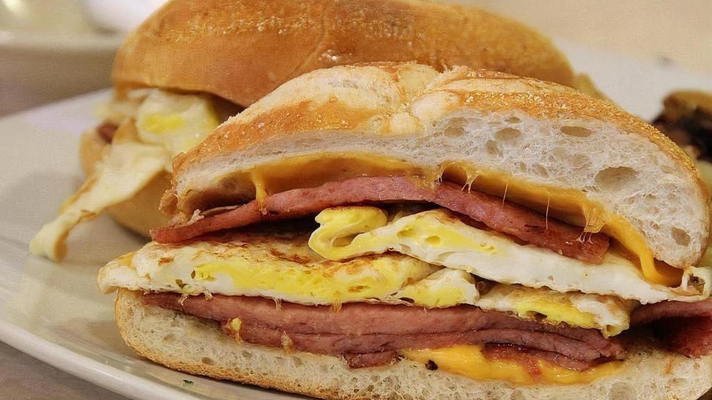 Ham, Egg & Cheese Sandwich · Ham, egg & (American) cheese sandwich with mayo, ketchup / roll bread.