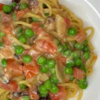 Spaghetti Carbonara · Bacon, peas, tomatoes, Pecorino Romano, egg yolk, garlic.