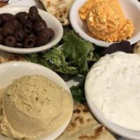 Greek Dips  · Hummus, spicy feta, and tzatziki sauce platter. Served with pita bread