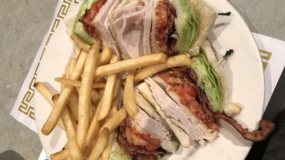 Turkey Club Sandwich · Turkey, lettuce, tomato, bacon.
Served with French fries, coleslaw and pickle.